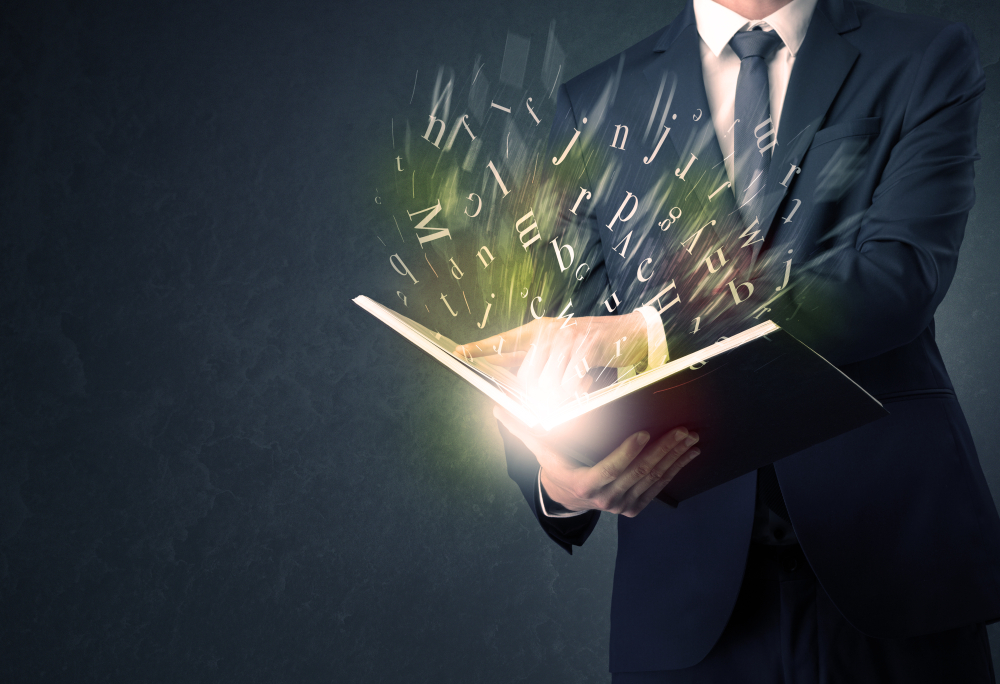 Businessman holding book with letter concept.